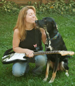 photo: Elizabeth Williams Bushey, her dog Tucker, and one of her eleven guitars.